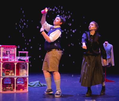 Actors on stage making bubbles