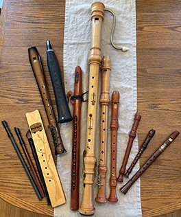 A number of wooden wind instruments on a table