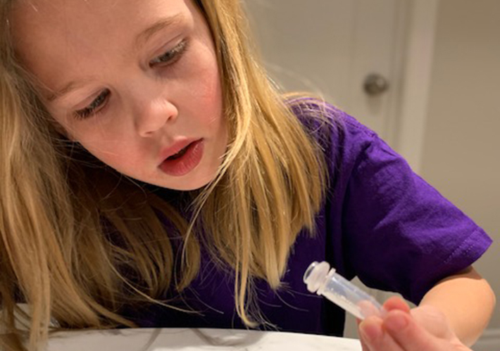 A student looking at a scientific instrument