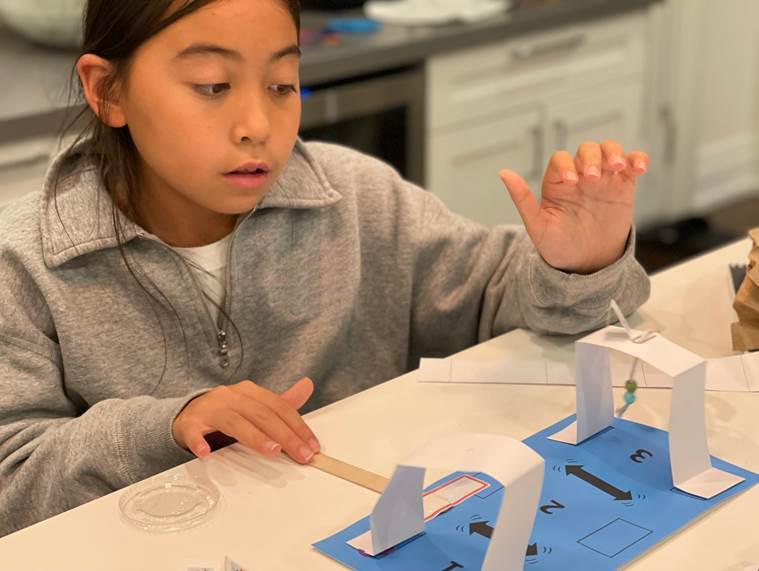 a student does an experiment with folded paper